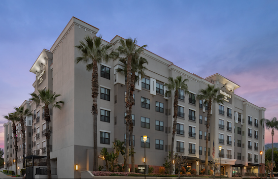 Residence Inn exterior at sunset with palm trees