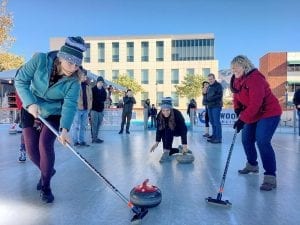 People playing curling at The Rink Downtown Burbank