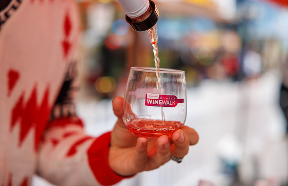 Winter Wine Walk cup with wine being poured into it