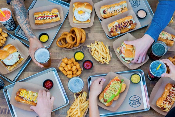 Top view image of Dog Haus burgers and appetizers