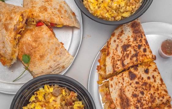 Bread & Breakfast quesadillas and bowls placed on a table.