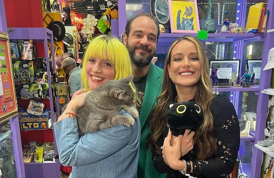 Catnip Coalition three people holding cats inside a vintage store