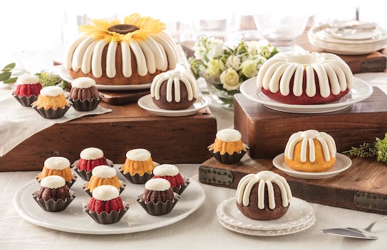 A group of Nothing Bundt Cakes on display including full cakes, bundtinies and single serve bundt cake