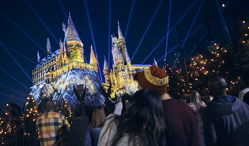 Christmas at the Wizarding World of Harry Potter with the castle decorated with Christmas lights