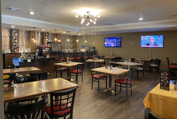 Sotos Cuban Kitchen dining room with wood tables and black and red chairs