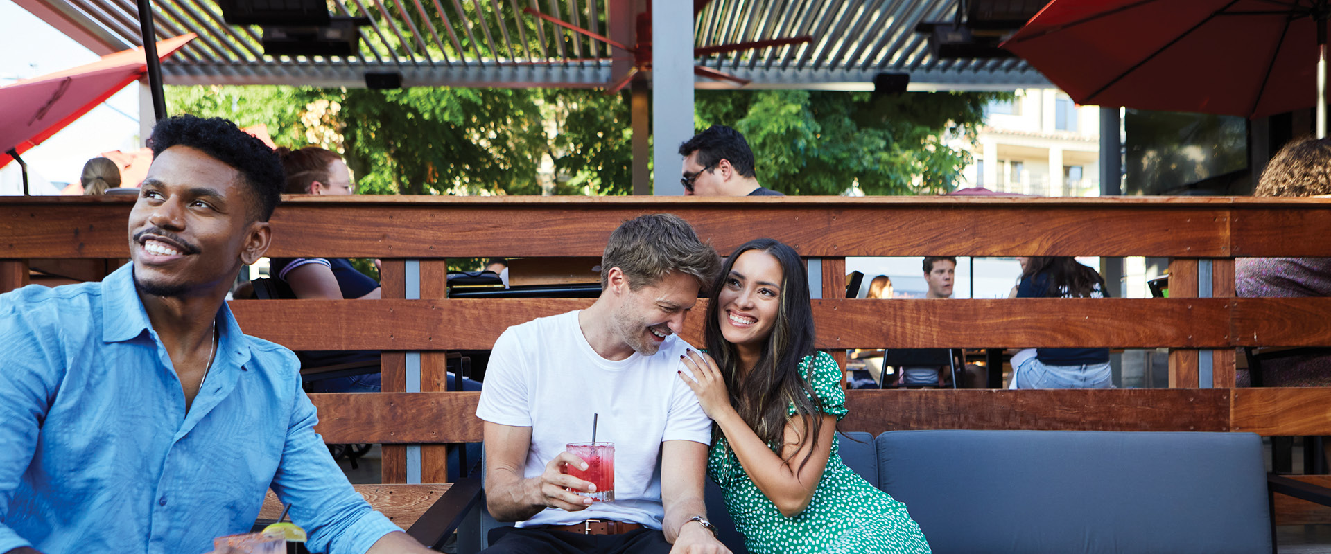 Friends enjoying drinks on an outdoor patio at a restaurant in Burbank.