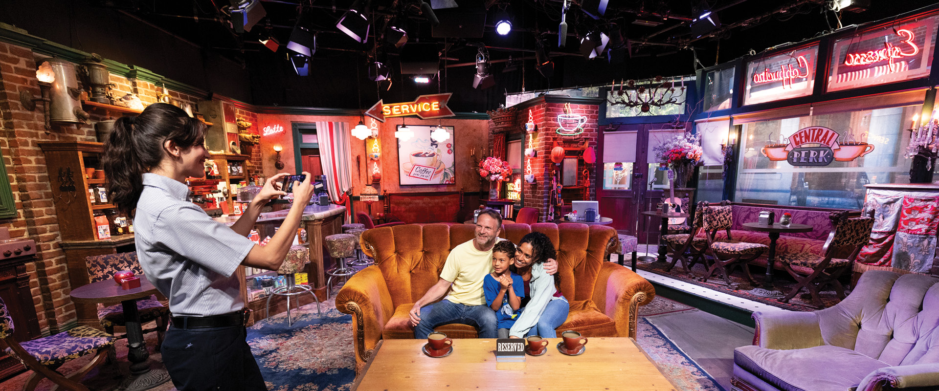 Family posing on the Central Perk set during the Warner Bros. Studio Tour Hollywood in Burbank.