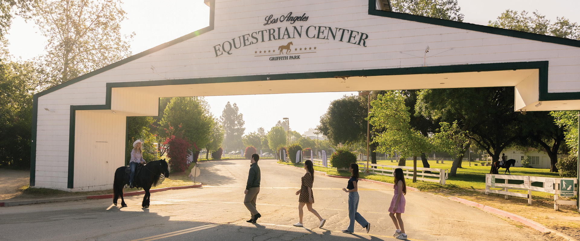 Visitors walking beneath the entrance to the Los Angeles Equestrian Center in Griffith Park near Burbank.