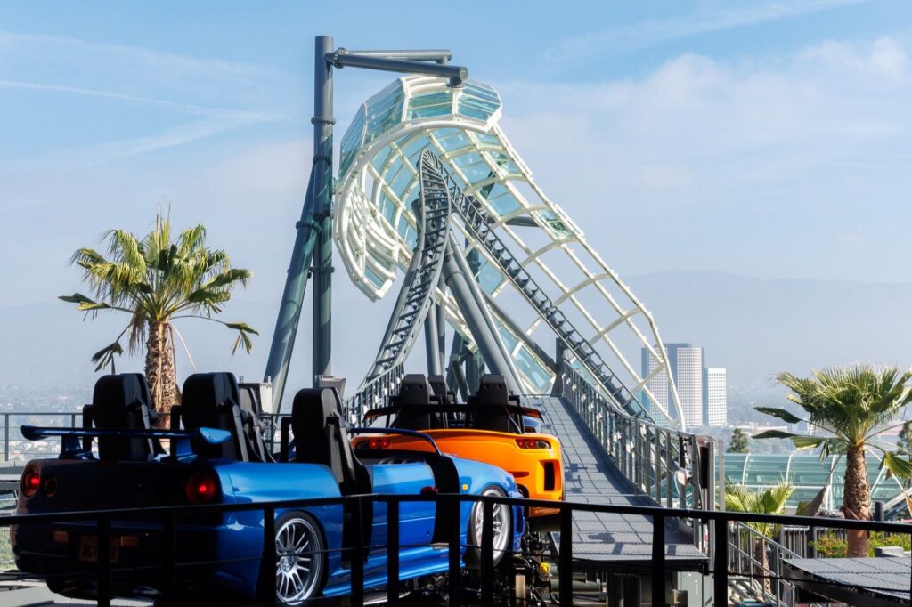 Fast & Furious: Hollywood Drift ride vehicles and coaster track with the Los Angeles skyline behind