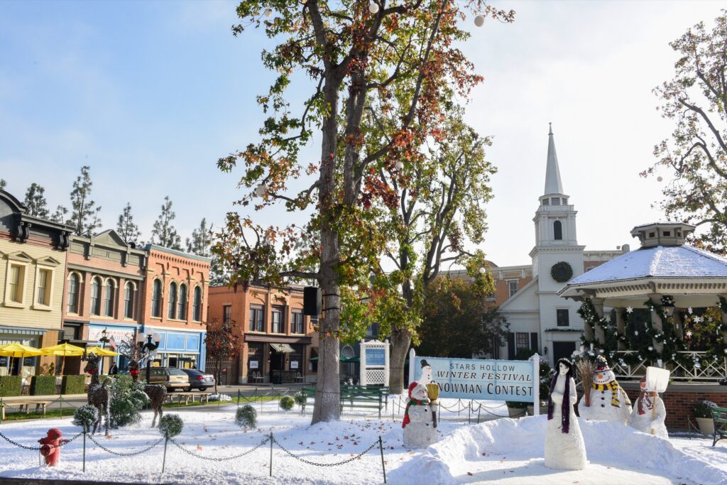 Stars Hollow town square dusted with snow, with the white church steeple and holiday decorations