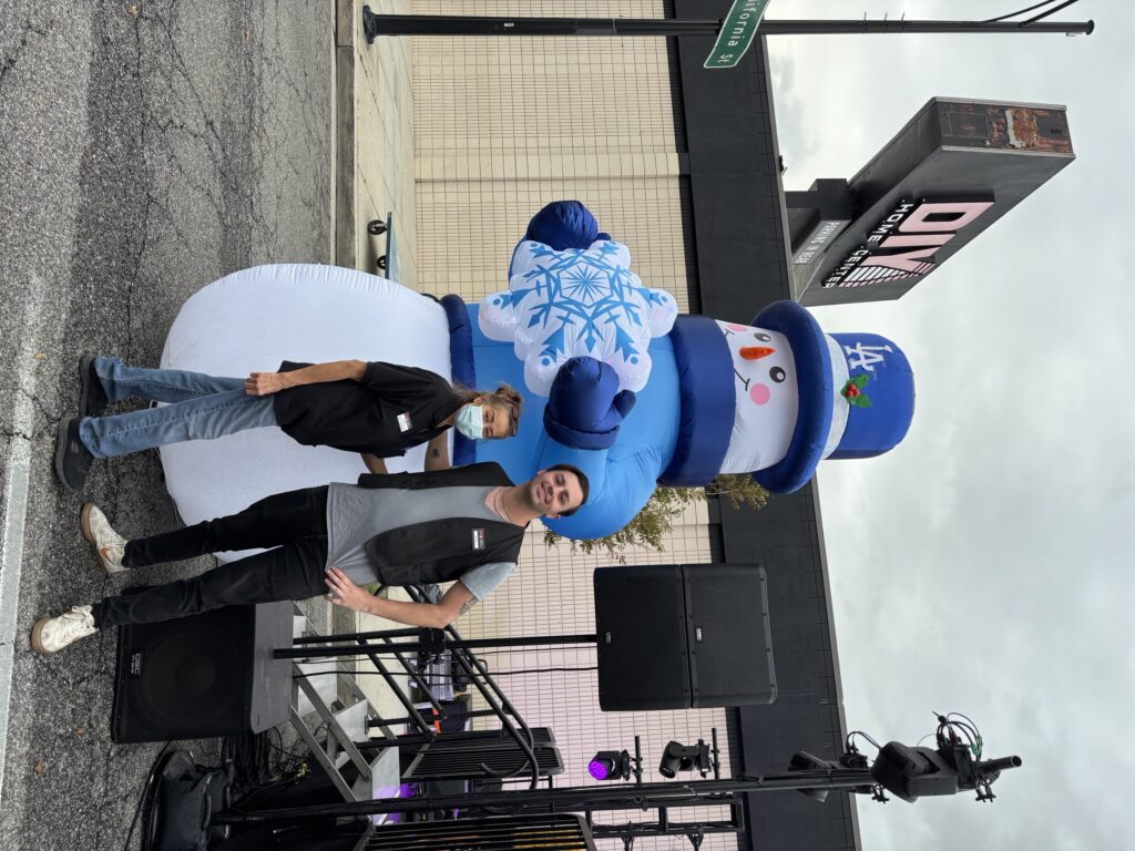 Visitors pose beside a giant inflatable snowman