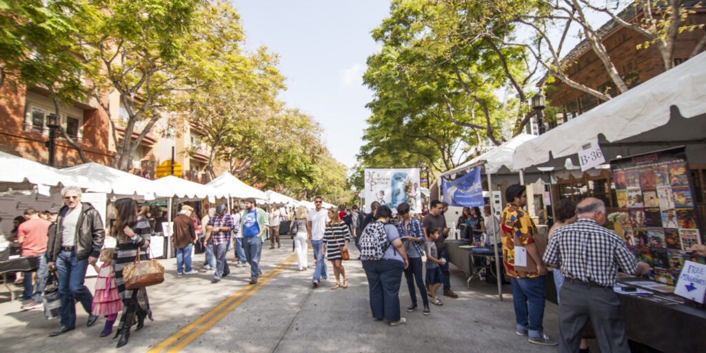 Rows of white artisan tents line a tree-shaded Downtown Burbank street